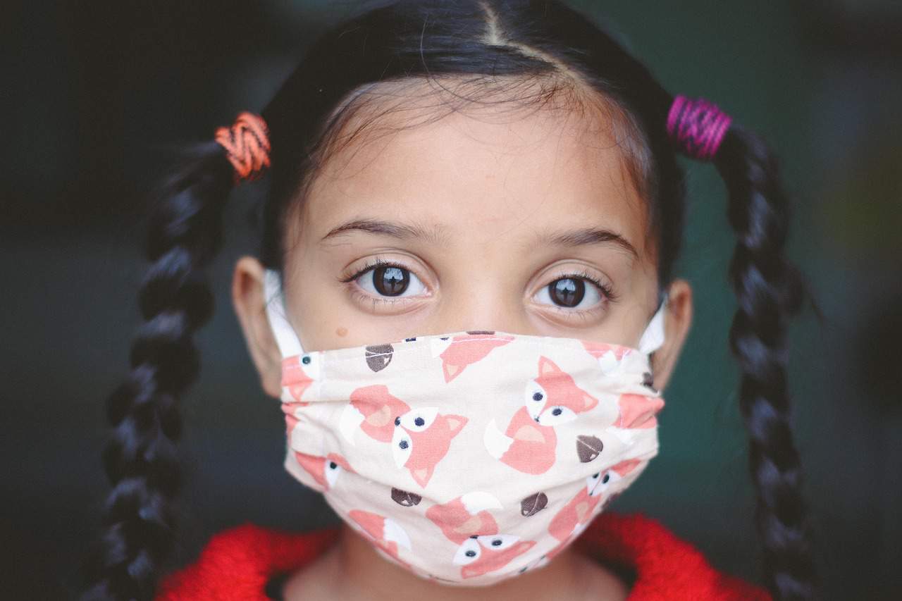 image shows girl wearing face mask